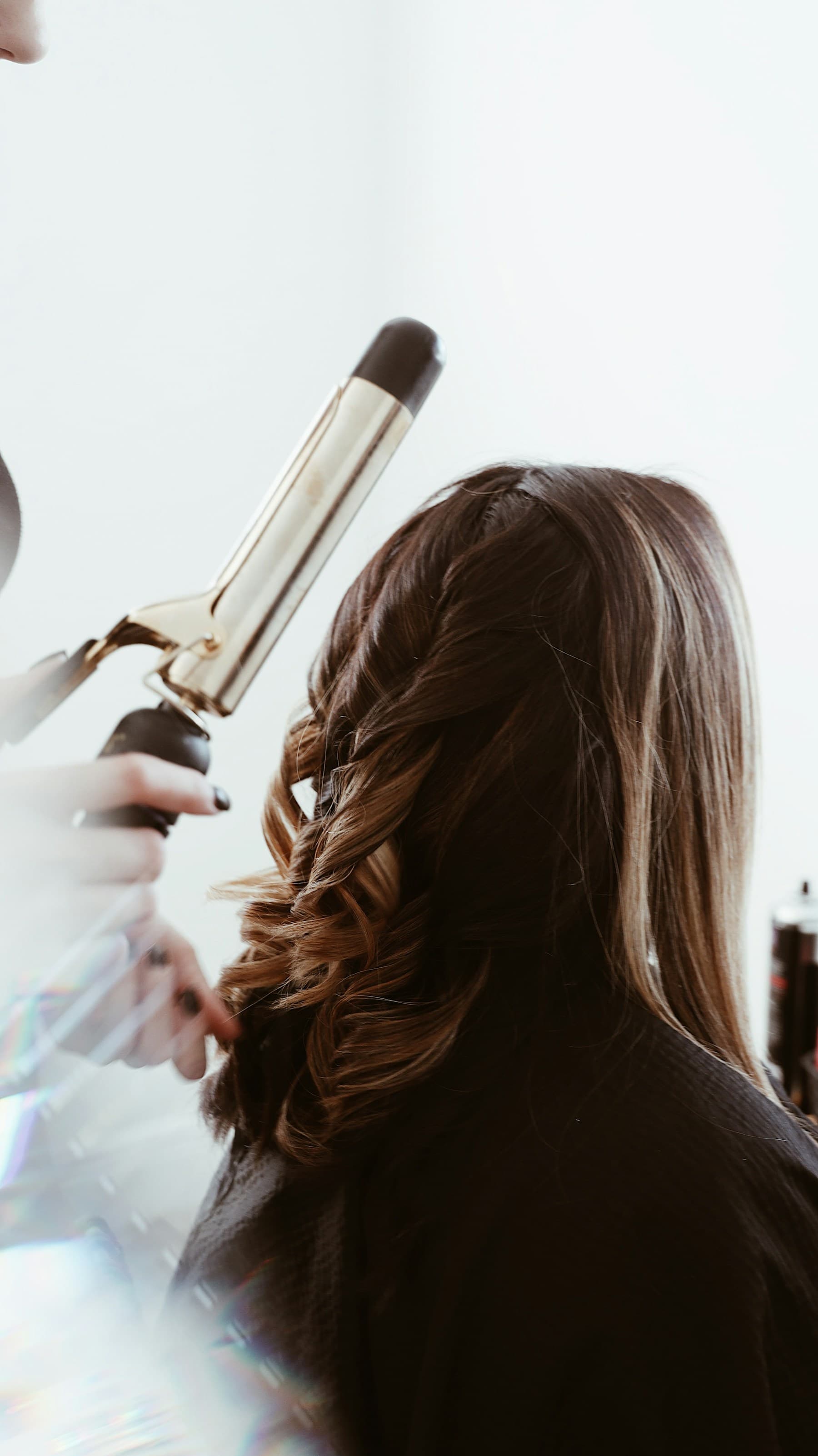 Brass curling iron on hair